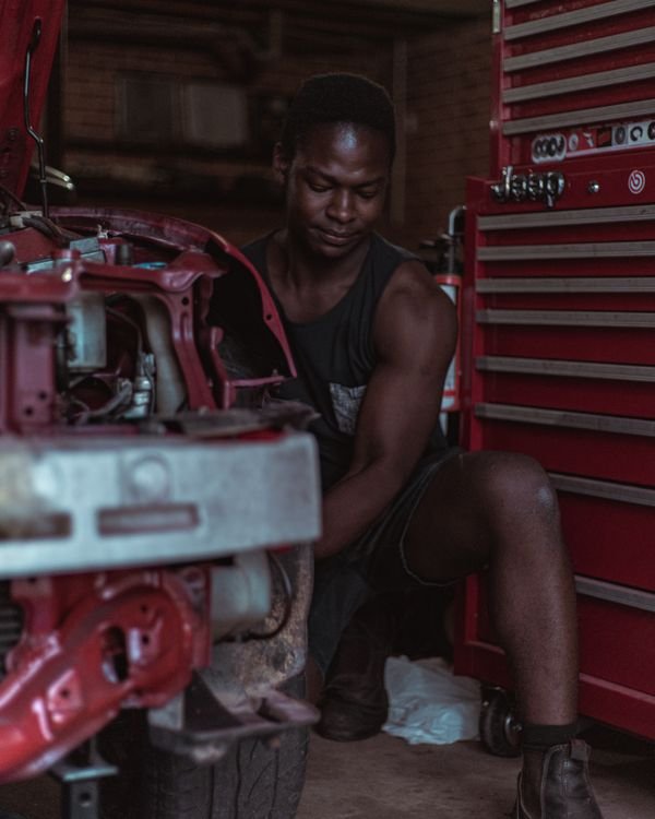Mechanic inspecting a car engine — stock photograph