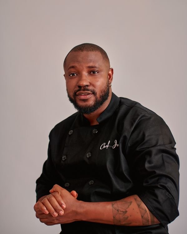 Black chef wearing a professional dark uniform — stock photograph